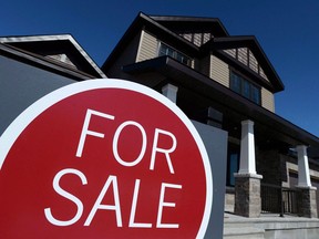 A sign advertises a new home for sale in Carleton Place, Ont., on March 17, 2015. A majority of first-time homebuyers say they maxed out their budgets when they bought their homes, according to a survey released today by the Canada Mortgage and Housing Corp.