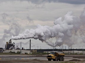 A dump truck works near the Syncrude oil sands extraction facility near the city of Fort McMurray, Alta., on June 1, 2014. Canada would have to cut its emissions almost in half over the next 12 years to meet the stiffer targets dozens of international climate change experts say is required to prevent catastrophic climate changes from the planet getting too warm. The United Nations Intergovernmental Panel on Climate Change says there will be irreversible changes and the entire loss of some ecosystems if the world doesn't take immediate and intensive action to cut greenhouse gas emissions far more than we are now.