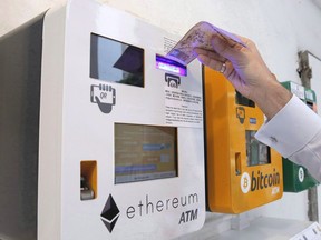 A senior Bank of Canada official says the central bank is looking at the key questions around the design of a digital currency and the issues surrounding such an idea. A man uses the Ethereum ATM, beside a Bitcoin ATM, in Hong Kong on May 11, 2018.