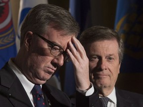Ottawa Mayor Jim Watson and Toronto Mayor John Tory are seen during a news conference at the Federation of Canadian Municipalities meetings in Ottawa on January 20, 2017. Ottawa Mayor Jim Watson is the target of test legal case that could prompt politicians all across the country to reconsider their use of social media. Three city residents are seeking a court order declaring that Watson infringed their constitutional right to freedom of expression by blocking them from his Twitter feed.