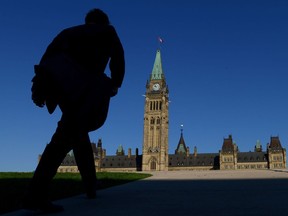 A man walks on Parliament Hill on September 15, 2014. A one-time Liberal MP from Calgary is being ordered by his peers to go to conciliation and training after a House of Commons investigation found some allegations against Darshan Kang constituted sexual harassment.