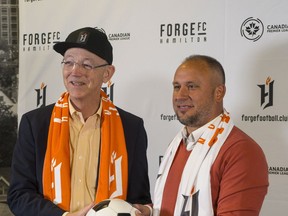 Forge FC has named Bobby Smyrniotis technical director and head coach of the Hamilton-based Canadian Premier League team. Forge FC team owner Bob Young, left, and head coach and technical director Bobby Smyrniotis pose during a press conference in Hamilton, Ont., in a Monday, Oct. 1, 2018, handout photo.