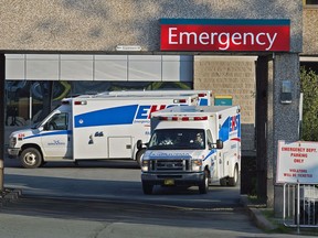 Paramedics are seen at the Dartmouth General Hospital in Dartmouth, N.S. on July 4, 2013. The New Brunswick government has released a discussion paper on the province's ambulance service but the opposition parties say action is needed to address a shortage paramedics and a decline in response times. The 37-page report says a majority of vacant paramedic jobs have bilingualism as a requirement.