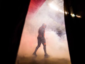 B.C. Lions offensive lineman Jovan Olafioye walks onto the field after being introduced before a CFL football game against the Hamilton Tiger-Cats in Vancouver on September 22, 2018. The B.C. Lions are once again clawing at a spot in the post-season as they prepare to host the Toronto Argonauts on Saturday. The Lions (6-7) are coming off a blowout 40-10 loss in Hamilton last week and currently sit outside of the playoff bracket, but could catch up with the Edmonton Eskimos and the Winnipeg Blue Bombers with a win over the struggling Argos (3-10).