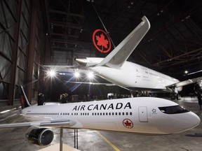 A model airplane is seen in front of the newly revealed Air Canada Boeing 787-8 Dreamliner aircraft at a hangar at the Toronto Pearson International Airport in Mississauga, Ont., on February 9, 2017. The Supreme Court of Canada has cleared the way for a class-action lawsuit against Air Canada and British Airways to proceed, dismissing an appeal by Canada's largest airline. Air Canada had sought to overturn an October 2017 Ontario Court of Appeal ruling that the class action could include foreign claimants despite playing out in Ontario courts.