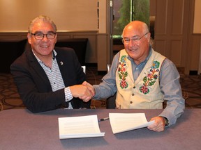 The Assembly of Nova Scotia Mi'kmaq Chiefs and the Metis National Council are pledging to work together on the growing number of people self-identifying as Metis, a trend both groups say is a concern. Glooscap First Nation Chief Sidney Peters, co-chairman of the Assembly of Nova Scotia Mi'kmaq Chiefs, and Clement Chartier, president of the Metis National Council, right, shake hands after signing a memorandum of understanding, in Halifax in a Wednesday, Oct. 3, 2018, handout photo. The groups have agreed to co-operate on the issue of individuals "misrepresenting" themselves as Metis in Nova Scotia.