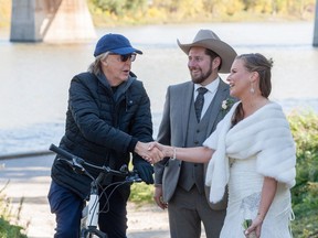 Paul McCartney greets newlyweds Steve Gregg and Jen Roscoe in Winnipeg in a handout photo.