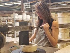Artist Lisa Miklash presses a more than century-old jigger machine into a lump of clay at the Medalta Potteries Factory, which is part of the Historic Clay District in Medicine Hat, Alta. on Thursday June 21, 2018. The old factory serves as a museum, artists' workspace, archaeological site and cultural hub.