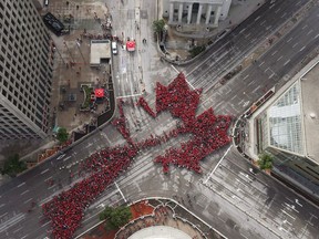 Winnipeggers got together today to celebrate Canada's 150th birthday by forming a "Living Leaf" at the historic downtown intersection of Portage and Main, Saturday, July 1, 2017.