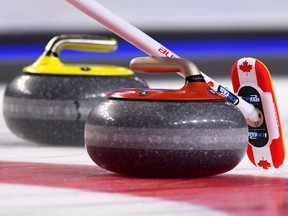 A Team Canada broom marks a stone during the Scotties Tournament of Hearts in St. Catharines, Ont., on Saturday, Feb. 18, 2017. Curling Canada high-performance director Gerry Peckham acknowledges that the current residency setup for elite Canadian curlers is an issue that is "timely and incredibly relevant." It seems quite possible change could soon be on the horizon.