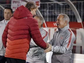 United States head coach Dave Sarachan, right, shakes hands with Peru head coach Ricardo Gareca, left, before an international friendly soccer match in East Hartford, Conn., Tuesday, Oct. 16, 2018.