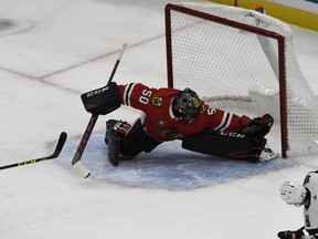 Chicago Blackhawks goaltender Corey Crawford (50) can't make a save on a goal scored by Arizona Coyotes left wing Lawson Crouse during the first period of an NHL hockey game Thursday, Oct. 18, 2018, in Chicago.