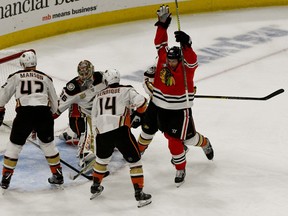 Chicago Blackhawks left wing Brandon Saad, right, celebrates after scoring a goal against Anaheim Ducks goaltender John Gibson (36), defenseman Josh Manson (42) and center Adam Henrique (14) during the first period of an NHL hockey game on Tuesday Oct. 23, 2018, in Chicago.