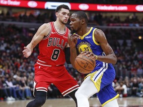 Golden State Warriors forward Kevin Durant, right, drives to the basket against Chicago Bulls guard Zach LaVine, left, during the first half of an NBA basketball game, Monday, Oct. 29, 2018, in Chicago.