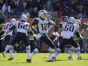 New England Patriots quarterback Tom Brady (12) throws during the first half of an NFL football game against the Chicago Bears Sunday, Oct. 21, 2018, in Chicago.