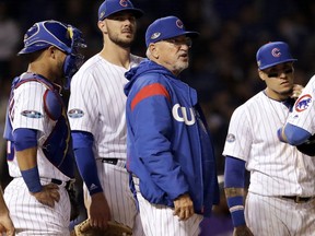 Chicago Cubs manager Joe Maddon talks to his team during the 13th inning of the National League wild-card playoff baseball game against the Colorado Rockies, Tuesday, Oct. 2, 2018, in Chicago. The Rockies won 2-1.
