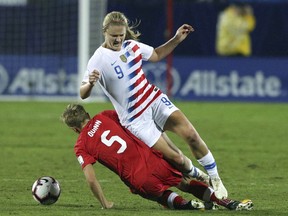 Canada defender Rebecca Quinn (5) slides into USA midfielder Lindsey Horan (9) in the first half of the finals of the CONCACAF Women's soccer Championship on Wednesday, Oct. 17, 2018, in Frisco, Texas.