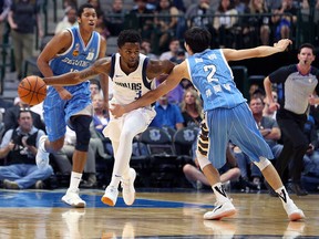 Daryl Macon #3 of the Dallas Mavericks drives the ball against Sun Haofeng #2 of the Beijing Ducks in Dallas on Sept. 29, 2018 in  Texas. EPSN is reporting that the Mavericks have hired Winnipeg gambler Haralabos “Bob” Voulgaris as their “director of quantitative research.”