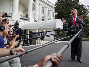 President Donald Trump speaks with reporters on the South Lawn of the White House, Monday, Oct. 8, 2018, in Washington.