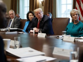 President Donald Trump listens during a cabinet meeting in the Cabinet Room of the White House, Wednesday, Oct. 17, 2018, in Washington. From left, Secretary of the Interior Ryan Zinke, Secretary of Transportation Elaine Chao, Trump, and Small Business Administration administrator Linda McMahon.