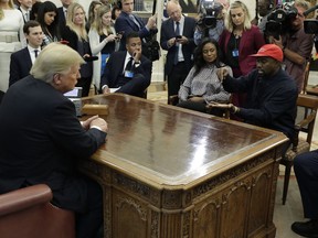 Rapper Kanye West speaks to President Donald Trump and others in the Oval Office of the White House, Thursday, Oct. 11, 2018, in Washington.