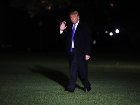 President Donald Trump waves as he crosses the South Lawn on his return to the White House, Saturday Oct. 13, 2018, in Washington, after a trip to Kentucky.