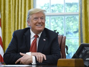President Donald Trump listens in the Oval Office of the White House in Washington, Wednesday, Oct. 17, 2018, during a meeting with workers. The meeting with workers was on, "Cutting the Red Tape, Unleashing Economic Freedom."