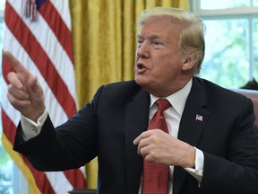 President Donald Trump speaks in the Oval Office of the White House in Washington, Wednesday, Oct. 17, 2018, during a meeting with workers. The meeting with workers was on, "Cutting the Red Tape, Unleashing Economic Freedom."