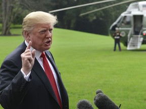 President Donald Trump speaks to reporters on the South Lawn of the White House in Washington, Monday, Oct. 8, 2018, as he heads to Marine One for the short trip to Andrews Air Force Base. Trump is traveling to Florida for the day.