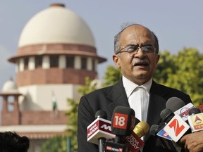FILE - In this Sept. 4, 2017 file photo, Indian lawyer and social activist Prashant Bhushan speaks to the journalists about the petition filed by two Rohingya Muslim refugees against their deportation to Myanmar, outside the Supreme Court in New Delhi, India. India's top court has allowed the federal government to send seven Rohingya Muslims back to Myanmar in the first deportation of members of the Myanmar minority group since it last year ordered their identification. The Supreme Court on Thursday, Oct. 4, 2018 rejected a plea by Bhushan, a defense attorney, to let them live in India as they feared reprisal in Myanmar. They were arrested in 2012 for entering India illegally and have been held in a prison.
