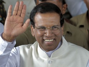 FILE - In this Jan. 9, 2015 file photo, Sri Lanka's then-incoming President Maithripala Sirisena waves to supporters as he leaves the election secretariat in Colombo, Sri Lanka. Presidential adviser Sarath Kongahage told reporters on Thursday, Oct. 18, 2018, security has been tightened for Sirisena as police investigate an alleged plot to assassinate him.