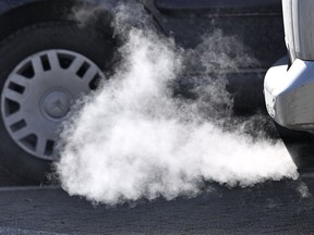 FILE - in this Feb. 27, 2018 file photo, a Diesel car runs in Essen, Germany. The German government backed plans to help reduce pollution from diesel vehicles.