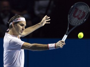 Switzerland's Roger Federer returns a ball to Romania's Marius Copil during the final at the Swiss Indoors tennis tournament at the St. Jakobshalle in Basel, Switzerland, on Sunday, Oct. 28, 2018.