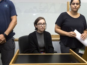 File - In this Thursday, Oct. 11, 2018 file photo, American Lara Alqasem, center, sits in a courtroom prior to a hearing at the district court in Tel Aviv, Israel. Alqasem asked Israel's Supreme Court to overturn an expulsion order over her alleged involvement in the boycott movement against Israel. Lara Alqasem has been held in detention since arriving in the country on Oct. 2 with a valid student visa.