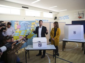 Mayoral candidate Ofer Berkovitch and his wife Dina arrive to cast their votes at a polling station during the municipal elections in Jerusalem, Tuesday, Oct. 30, 2018.