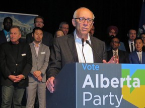 Alberta Party Leader Stephen Mandel, with nominated candidates standing behind him, speaks to members at the party's annual general meeting in Edmonton on Saturday, October 20, 2018.