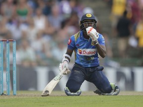 Sri Lanka's Akila Dananjaya watches after successfully diving into his crease during their fourth one-day international cricket match with England in Pallekele, Sri Lanka, Saturday, Oct. 20, 2018.