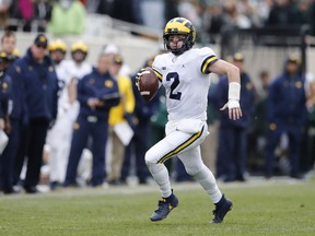 Michigan quarterback Shea Patterson scrambles during the first half of an NCAA college football game against Michigan State, Saturday, Oct. 20, 2018, in East Lansing, Mich.