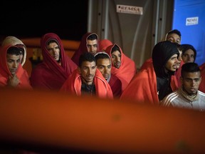 In this photo taken on Saturday, Oct. 27, 2018, migrants arrive at the port of San Roque, southern Spain, after being rescued by Spain's Maritime Rescue Service in the Strait of Gibraltar. Spain's maritime rescue service saved 520 people trying to cross from Africa to Spain's shores on Saturday. Also, one boat with 70 migrants arrived to the Canary Islands. Over 1,960 people have died trying to cross the Mediterranean to Europe this year, according to the United Nations.
