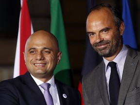 French Prime Minister Edouard Philippe, right, greets Britain's Home Secretary Sajid Javid, as he arrives at the G6 Interior Ministers' meeting in Lyon, central France, Monday, Oct. 8, 2018.