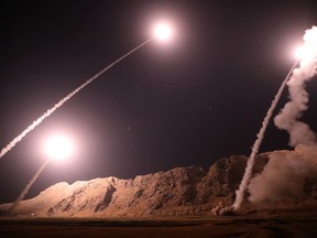 In this photo released on Monday, Oct. 1, 2018, by the Iranian Revolutionary Guard, missiles are fired from city of Kermanshah in western Iran targeting the Islamic State group in Syria. Iran's paramilitary Revolutionary Guard said Monday it launched ballistic missiles into eastern Syria targeting militants it blamed for a recent attack on a military parade. (Sepahnews via AP)