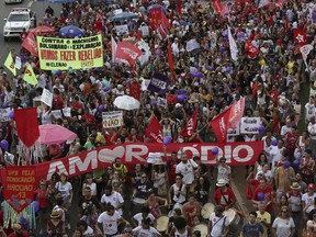 With a banner in Portuguese that reads "More Love and Less Hatred," hundreds of demonstrators marched during a protest called "Women against Bolsonaro," in Brasilia, Brazil, Saturday, Oct. 20, 2018. Women and left-wing militants held protests across the country against the right-wing presidential candidate Jair Bolsonaro.