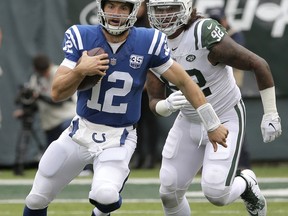 Indianapolis Colts quarterback Andrew Luck (12) scrambles as New York Jets defensive end Leonard Williams (92) chases him during the first half of an NFL football game, Sunday, Oct. 14, 2018, in East Rutherford, N.J.