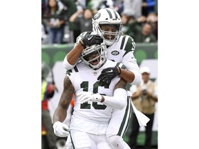 New York Jets wide receiver Terrelle Pryor (16) is congratulated by wide receiver Jermaine Kearse (10) after catching a touchdown pass from quarterback Sam Darnold, not pictured, during the first half of an NFL football game, Sunday, Oct. 14, 2018, in East Rutherford, N.J.