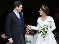 Britain's Princess Eugenie and Jack Brooksbank leave St George's Chapel after their wedding at Windsor Castle, near London, England, Friday Oct. 12, 2018.