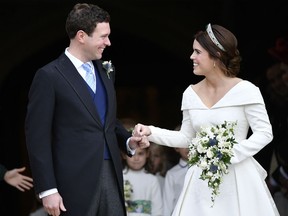 Britain's Princess Eugenie and Jack Brooksbank leave St George's Chapel after their wedding at Windsor Castle, near London, England, Friday Oct. 12, 2018.