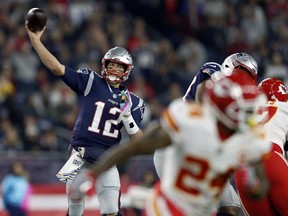 New England Patriots quarterback Tom Brady (12) passes under pressure from the Kansas City Chiefs during the first half of an NFL football game, Sunday, Oct. 14, 2018, in Foxborough, Mass.