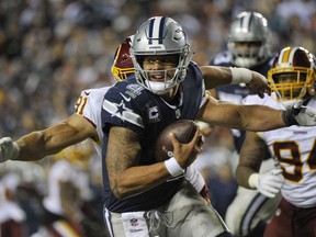 Washington Redskins linebacker Ryan Kerrigan (91) closes in on Dallas Cowboys quarterback Dak Prescott (4) forcing a fumble and a touchdown during the second half of an NFL football game, Sunday, Oct. 21, 2018 in Landover, Md.
