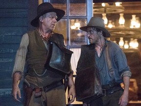 Joaquin Phoenix, right, and John C. Reilly in a scene from The Sisters Brothers.
