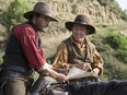 Joaquin Phoenix, left, and John C. Reilly in a scene from The Sisters Brothers.